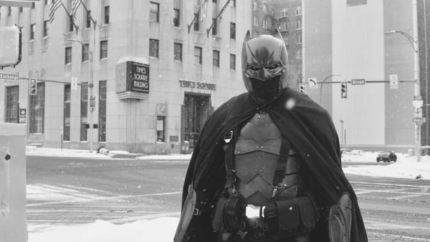 On a cold and windy Friday afternoon, people drive by the Blue Cross Arena, honking their horns and stopping for pictures. The source of their attention is a familiar face to many. He's known as the Dark Knight - it's Batman Dsc05504  